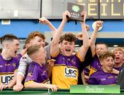 1 July 2023; Carryduff captain Aodhán McEvoy lifts the trophy after his side's victory in the Division one shield final at the John West Féile Peile na nÓg Finals 2023 at the Connacht GAA Centre of Excellence in Bekan, Mayo. Photo by Stephen Marken/Sportsfile