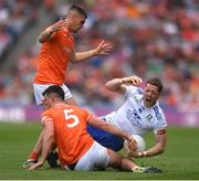 1 July 2023; Conor McManus of Monaghan is tackled by Armagh players, from left, Greg McCabe and Conor O'Neill during the GAA Football All-Ireland Senior Championship quarter-final match between Armagh and Monaghan at Croke Park in Dublin. Photo by John Sheridan/Sportsfile