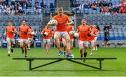 1 July 2023; Rian O'Neill of Armagh jumps the bench on his way to the team photograph before the GAA Football All-Ireland Senior Championship quarter-final match between Armagh and Monaghan at Croke Park in Dublin. Photo by Piaras Ó Mídheach/Sportsfile