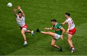 1 July 2023; David Clifford of Kerry kicks a point despite the best efforts of Pádraig Hampsey and Joe Oguz of Tyrone during the GAA Football All-Ireland Senior Championship quarter-final match between Kerry and Tyrone at Croke Park in Dublin. Photo by Brendan Moran/Sportsfile