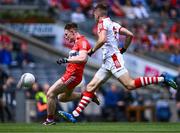 2 July 2023; Ethan Doherty of Derry shoots under pressure from Ian Maguire of Cork during the GAA Football All-Ireland Senior Championship quarter-final match between Derry and Cork at Croke Park in Dublin. Photo by Piaras Ó Mídheach/Sportsfile