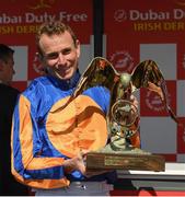 2 July 2023; Jockey Ryan Moore celebrates with the trophy after winning the Dubai Duty Free Irish Derby on Auguste Rodin during day three of the Dubai Duty Free Irish Derby Festival at Curragh Racecourse in Kildare. Photo by Matt Browne/Sportsfile