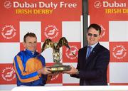 2 July 2023; Jockey Ryan Moore and trainer Aidan O'Brien celebrate with the trophy after winning the Dubai Duty Free Irish Derby on Auguste Rodin during day three of the Dubai Duty Free Irish Derby Festival at Curragh Racecourse in Kildare. Photo by Matt Browne/Sportsfile