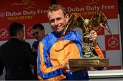 2 July 2023; Jockey Ryan Moore celebrates with the trophy after winning the Dubai Duty Free Irish Derby on Auguste Rodin during day three of the Dubai Duty Free Irish Derby Festival at Curragh Racecourse in Kildare. Photo by Matt Browne/Sportsfile