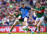 2 July 2023; Colm Basquel of Dublin scores his side's first goal, under pressure from Mayo players Pádraig O'Hora, left, and Jack Coyne during the GAA Football All-Ireland Senior Championship quarter-final match between Dublin and Mayo at Croke Park in Dublin. Photo by Piaras Ó Mídheach/Sportsfile