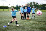 3 July 2023; Sophia Maher takes a penalty in front of Republic of Ireland's Lily Agg during a visit from Republic of Ireland women's team players to the Hartstown Huntstown FC INTERSPORT Elverys FAI Football Camp in Dublin. Photo by Stephen McCarthy/Sportsfile