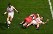 2 July 2023; John O'Rourke of Cork plays the ball as teammate Daniel O'Mahony recovers from a tackle by Paul McNeil of Derry during the GAA Football All-Ireland Senior Championship quarter-final match between Derry and Cork at Croke Park in Dublin. Photo by Brendan Moran/Sportsfile