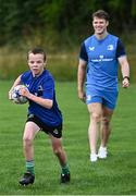 5 July 2023; Paddy McNaughton watched by Leinster player Rob Russell during a Bank of Ireland Leinster Rugby Summer Camp at Stillorgan-Rathfarnham RFC in Dublin. Photo by Harry Murphy/Sportsfile