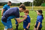 5 July 2023; Leinster players Rob Russell and Jordan Larmour signs autographs during a Bank of Ireland Leinster Rugby Summer Camp at Stillorgan-Rathfarnham RFC in Dublin. Photo by Harry Murphy/Sportsfile