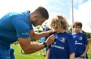 5 July 2023; Jordan Larmour signs an autograph for Cormac Newman during a Bank of Ireland Leinster Rugby Summer Camp at Stillorgan-Rathfarnham RFC in Dublin. Photo by Harry Murphy/Sportsfile