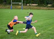 5 July 2023; Daniel Ortega is tackled Blair Munro during a Bank of Ireland Leinster Rugby Summer Camp at Stillorgan-Rathfarnham RFC in Dublin. Photo by Harry Murphy/Sportsfile