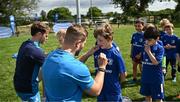 5 July 2023; Leinster players Jordan Larmour and Rob Russell sign autographs during a Bank of Ireland Leinster Rugby Summer Camp at Stillorgan-Rathfarnham RFC in Dublin. Photo by Harry Murphy/Sportsfile