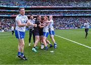 1 July 2023; Monaghan goalkeeper Rory Beggan is surrounded by his teammates after their side's victory in the penalty shoot-out of the GAA Football All-Ireland Senior Championship quarter-final match between Armagh and Monaghan at Croke Park in Dublin. Photo by Piaras Ó Mídheach/Sportsfile