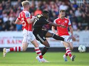 7 July 2023; Babatunde Owolabi of Cork City shoots under pressure from Jay McGrath, left, and Harry Brockbank of St Patrick's Athletic during the SSE Airtricity Men's Premier Division match between St Patrick's Athletic and Cork City at Richmond Park in Dublin. Photo by Piaras Ó Mídheach/Sportsfile