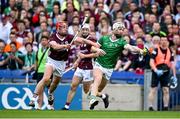 8 July 2023; Cian Lynch of Limerick holds off Ronan Glennon of Galway and makes a pass to a teammate in the lead up to his side's second goal during the GAA Hurling All-Ireland Senior Championship semi-final match between Limerick and Galway at Croke Park in Dublin. Photo by Brendan Moran/Sportsfile