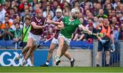 8 July 2023; Cian Lynch of Limerick holds off Ronan Glennon of Galway and makes a pass to a teammate in the lead up to his side's second goal during the GAA Hurling All-Ireland Senior Championship semi-final match between Limerick and Galway at Croke Park in Dublin. Photo by Brendan Moran/Sportsfile