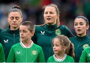 6 July 2023; Republic of Ireland players, from left, Sinead Farrelly, Kyra Carusa and Marissa Sheva stand for the playing of the National Anthem before the women's international friendly match between Republic of Ireland and France at Tallaght Stadium in Dublin. Photo by Stephen McCarthy/Sportsfile