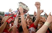 9 July 2023; Derry players including Tommy Rogers, right, celebrate with the Tom Markham Cup after the Electric Ireland GAA Football All-Ireland Minor Championship final match between Derry and Monaghan at Box-IT Athletic Grounds in Armagh. Photo by Ramsey Cardy/Sportsfile