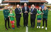 14 July 2023; Pictured at the launch of the Republic of Ireland women's national team commemorative coin are, from left, Republic of Ireland women's national team player Abbie Larkin, Daisy White, age 11, of Shelbourne, FAI President Gerry McAnaney, Minister of State at Department of Tourism, Culture, Arts, Gaeltacht, Sport and Media Thomas Byrne TD, Governor of the Central Bank of Ireland Gabriel Makhlouf, Ellie O'Mahony, age 13, of Shelbourne, and Republic of Ireland women's national team player Jamie Finn, at Tolka Park in Dublin. Photo by Seb Daly/Sportsfile