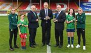 14 July 2023; Pictured at the launch of the Republic of Ireland women's national team commemorative coin are, from left, Republic of Ireland women's national team player Abbie Larkin, Daisy White, age 11, of Shelbourne, FAI President Gerry McAnaney, Minister of State at Department of Tourism, Culture, Arts, Gaeltacht, Sport and Media Thomas Byrne TD, Governor of the Central Bank of Ireland Gabriel Makhlouf, Ellie O'Mahony, age 13, of Shelbourne, and Republic of Ireland women's national team player Jamie Finn, at Tolka Park in Dublin. Photo by Seb Daly/Sportsfile