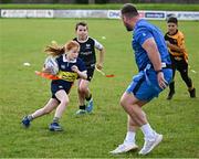 12 July 2023; Clodagh Phelan makes a break watched by Leinster player Ed Byrne during a Bank of Ireland Leinster Rugby summer camp at County Carlow FC in Carlow.  Photo by Harry Murphy/Sportsfile