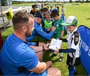 12 July 2023; Leinster player Ed Byrne signs an autograph for Asher Vidal during a Bank of Ireland Leinster Rugby summer camp at County Carlow FC in Carlow.  Photo by Harry Murphy/Sportsfile