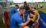 12 July 2023; Leinster player Ed Byrne signs an autograph for Donagh Lancaster during a Bank of Ireland Leinster Rugby summer camp at County Carlow FC in Carlow.  Photo by Harry Murphy/Sportsfile
