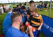 12 July 2023; Leinster player Ed Byrne signs an autograph for Mark Kelly during a Bank of Ireland Leinster Rugby summer camp at County Carlow FC in Carlow.  Photo by Harry Murphy/Sportsfile