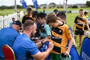 12 July 2023; Leinster player Ed Byrne signs an autograph for Donagh Murphy during a Bank of Ireland Leinster Rugby summer camp at County Carlow FC in Carlow.  Photo by Harry Murphy/Sportsfile