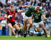 15 July 2023; Daniel Magill of Down is tackled by Conor Gray and Ronan Jones, hidden, of Meath during the Tailteann Cup Final match between Down and Meath at Croke Park in Dublin. Photo by Brendan Moran/Sportsfile