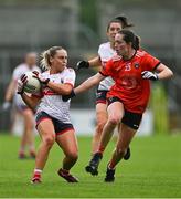 15 July 2023; Laura O'Mahony of Cork in action against Niamh Reel of Armagh during the TG4 Ladies Football All-Ireland Senior Championship quarter-final match between Armagh and Cork at BOX-IT Athletic Grounds in Armagh. Photo by Ben McShane/Sportsfile