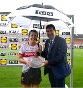 15 July 2023; Ciara O'Sullivan of Cork receives the Player of the Match award from Mícheál Naughton, Uachtarán LGFA, after the 2023 TG4 All-Ireland Ladies Senior Football quarter-final match between Armagh and Cork at the Box-IT Athletic Grounds, Armagh. Photo by Ben McShane/Sportsfile