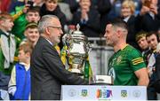 15 July 2023; Uachtarán Chumann Lúthchleas Gael Larry McCarthy presents the Tailteann Cup to Meath captain Donal Keogan of Meath after the Tailteann Cup Final match between Down and Meath at Croke Park in Dublin. Photo by Brendan Moran/Sportsfile