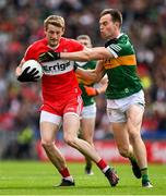 16 July 2023; Brendan Rogers of Derry is tackled by Jack Barry of Kerry during the GAA Football All-Ireland Senior Championship Semi-Final match between Derry and Kerry at Croke Park in Dublin. Photo by Brendan Moran/Sportsfile