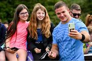 17 July 2023; Scott Penny takes a selfie with Ella Evans, left, and Lily McWilliams after a Leinster rugby squad training and gym session at Wicklow RFC in Wicklow. Photo by Brendan Moran/Sportsfile