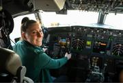 19 July 2023; Republic of Ireland's Lucy Quinn sits in the cockpit under the supervision of first officer Rupert Monahan at Sydney Airport, Australia, upon the team's arrival from their base in Brisbane, for their opening FIFA Women's World Cup 2023 group match against co-host Australia, on Thursday. Photo by Stephen McCarthy/Sportsfile