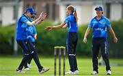19 July 2023; Typhoons players including Alice Tector, centre, and Rebecca Stokell, left, celebrate the wicket of Lara Maritz of Scorchers during the Evoke Super Series 2023 match between Typhoons and Scorchers at Pembroke Cricket Club in Dublin. Photo by Sam Barnes/Sportsfile