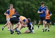 21 July 2023; Cal Casey is tackled during the Leinster Rugby School of Excellence at The King's Hospital in Dublin. Photo by Piaras Ó Mídheach/Sportsfile