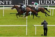 22 July 2023; Savethelastdance, left, with Ryan Moore up, crosses the line to win the Juddmonte Irish Oaks, from second place Bluestocking, left, with Colin Keane up, during day one of the Juddmonte Irish Oaks Weekend at The Curragh Racecourse in Kildare. Photo by Seb Daly/Sportsfile