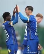 22 July 2023; Samuel Perry of Waterford, right, is congratulated by teammate Serge Atakayi after scoring his side's second goal during the Sports Direct Men’s FAI Cup First Round match between St. Michael’s and Waterford at Cooke Park in Tipperary. Photo by Michael P Ryan/Sportsfile