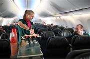 23 July 2023; Republic of Ireland's flight attendant Ruesha Littlejohn attends to performance analyst Andrew Holt during their flight from their base in Brisbane to Perth for their FIFA Women's World Cup 2023 group match against Canada, on Wednesday. Photo by Stephen McCarthy/Sportsfile