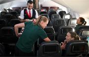 23 July 2023; Republic of Ireland's flight attendant Ruesha Littlejohn attends to Harriet Scott during their flight from their base in Brisbane to Perth for their FIFA Women's World Cup 2023 group match against Canada, on Wednesday. Photo by Stephen McCarthy/Sportsfile