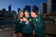 24 July 2023; Republic of Ireland players, from left, Kyra Carusa, Izzy Atkinson and Abbie Larkin review their TikTok dance recording at the Elizabeth Quay Bridge in Perth, Australia, ahead of their second Group B match of the FIFA Women's World Cup 2023, against Canada. Photo by Stephen McCarthy/Sportsfile