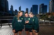 24 July 2023; Republic of Ireland players, from left, Kyra Carusa, Abbie Larkin and Izzy Atkinson review their TikTok dance recording at the Elizabeth Quay Bridge in Perth, Australia, ahead of their second Group B match of the FIFA Women's World Cup 2023, against Canada. Photo by Stephen McCarthy/Sportsfile
