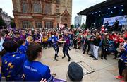 24 July 2023; Attendees dance in front of the Guildhall during the opening ceremony of the FRS Recruitment GAA World Games 2023 in Derry. Photo by Ramsey Cardy/Sportsfile