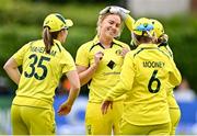 25 July 2023; Kim Garth of Australia, second  from left, celebrates with team-mates, from left, Georgia Wareham, Beth Mooney and Alyssa Healy after bowling Leah Paul of Ireland out during match two of the Certa Women’s One Day International Challenge between Ireland and Australia at Castle Avenue in Dublin. Photo by Sam Barnes/Sportsfile