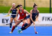 25 July 2023; Hannah McLouglin of Ireland and Mariana De Jesús Lagos of Chile during the women's hockey international match between Ireland and Chile at the Sport Ireland Campus in Dublin. Photo by Ben McShane/Sportsfile