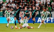 27 July 2023; Johnny Kenny of Shamrock Rovers evades the tackle of Samy Mmaee of Ferencvaros during the UEFA Europa Conference League Second Qualifying Round First Leg match between Ferencvaros and Shamrock Rovers at Ferencváros Stadion in Budapest, Hungary. Photo by David Balogh/Sportsfile