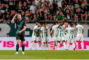 27 July 2023; Sean Hoare of Shamrock Rovers reacts as Ferencváros players celebrate a goal during the UEFA Europa Conference League Second Qualifying Round First Leg match between Ferencvaros and Shamrock Rovers at Ferencváros Stadion in Budapest, Hungary. Photo by David Balogh/Sportsfile