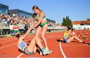 27 July 2023; Enya Silkena of Team Ireland helps up Viola Hambidge of Team Estonia after competing in the girls heptathlon 800m during day four of the 2023 Summer European Youth Olympic Festival at Poljane Athletics Stadium in Maribor, Slovenia. Photo by Tyler Miller/Sportsfile